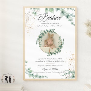 May include: A white framed print with a green watercolor floral design. The print features a photo of a baby in a white hat and a stuffed animal. The text on the print reads "Beatrice, Mon Bapt&ecirc;me le 17 Juin 2022, Eglise Saint Jacques de Capelle la Grande, Je suis n&eacute; le 17 avril 2022 &agrave; 13h03, mon poids &eacute;tait de 3,65 kg et ma taille de 51 cm, Mes parents GARANCE et MOUSSA ont choisi R&eacute;gine & William pour &ecirc;tre ma marraine et mon parrain et m'accompagner dans la vie."