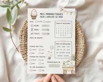 Puede incluir: Tarjeta de juego para baby shower con el texto "MES PRONOSTIQUES POUR L'ARRIVÉE DE BÉBÉ" en francés. La tarjeta incluye secciones para el sexo, la hora, el peso, la altura, el color de ojos y cabello, y la fecha de nacimiento. Decorada con ilustraciones.