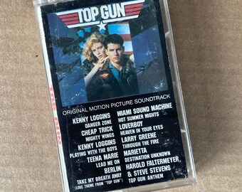 Loggins, Berlin, Cheap Trick, et. al. ‘TOP GUN’ original motion picture soundtrack on a Columbia audio cassette.