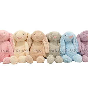 May include: Six plush bunny toys in different colors: pink, cream, tan, gray, blue, and purple. The bunnies are all sitting with their ears up and their eyes closed.