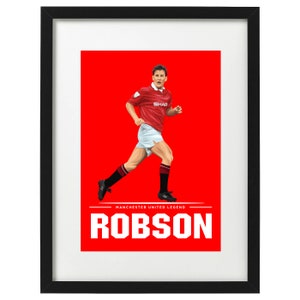 May include: Framed print featuring a soccer player in a red jersey with the word "SHAR" on the front, white shorts, and black socks. The background is red, with the name "ROBSON" in white block letters below the player.
