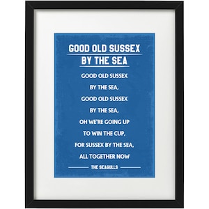 May include: A blue and white framed print with the text "Good Old Sussex By The Sea" and the lyrics to a song about the Sussex Seagulls.