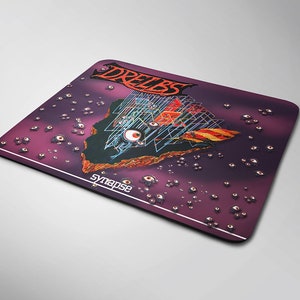 May include: A purple mouse mat featuring a graphic of a floating island with a geometric structure and the word "DREIBS" in red and white lettering. The island is surrounded by small, white eyes. The text "synapse" is printed in white at the bottom of the mouse mat.
