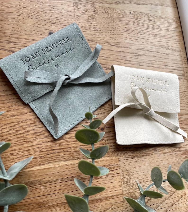 May include: Two small, fabric gift bags with a satin ribbon tie. The bags are light green and white. The bags are personalized with the text "To my beautiful bridesmaid".