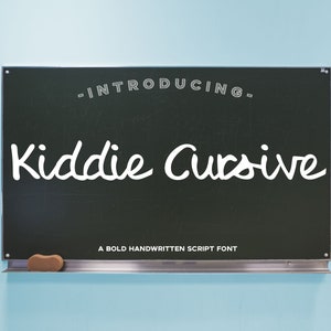 May include: A chalkboard with the text "Introducing Kiddie Cursive" written in white cursive font. Below the text is the phrase "A bold handwritten script font".