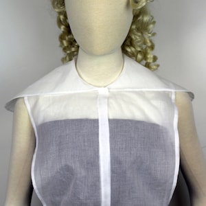 May include: A white sheer blouse with a large, detachable collar. The blouse has a button closure and a gathered hem.