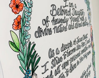 May include: A white poster with handwritten text and a floral border. The text reads "I am a Beloved Daughter of heavenly Parents..." The border features colorful flowers and greenery, including red poppies and blue forget-me-nots.
