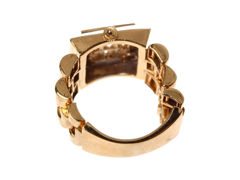 May include: A gold-toned ring with a watch face set into the band. The band is made of a series of linked squares.
