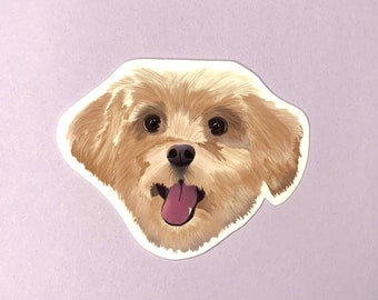May include: A close-up of a sticker featuring a cartoon illustration of a light brown dog with its tongue sticking out. The dog has a white patch on its chest and is looking directly at the viewer.