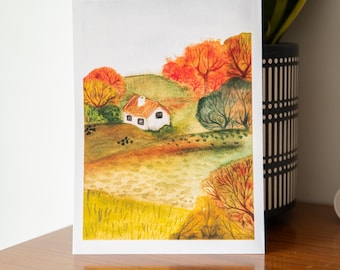 May include: A watercolor painting on paper depicting a small white house with an orange roof nestled in a rolling landscape. The scene features vibrant autumn foliage in shades of red, orange, and yellow, with green hills and textured grassy fields.