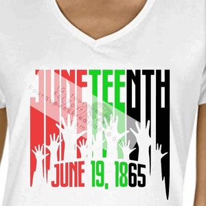 May include: White v-neck t-shirt with a graphic design. The design features the word "JUNETEENTH" in red, green, and black, with raised hands and the date "JUNE 19, 1865". The shirt also includes social media contact information.