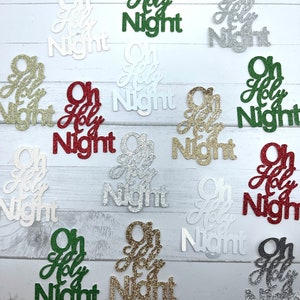 May include: A collection of 12 "Oh Holy Night" Christmas ornaments in various colors, including green, gold, red, white, and silver. The ornaments are made of glitter paper and have a festive, sparkly appearance.