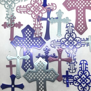 May include: Assortment of decorative metal crosses in various colors and designs. The crosses are made of metal and have a shiny finish. They are perfect for adding a touch of faith and elegance to any home decor.
