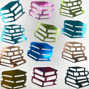 May include: A collection of colorful, metallic book-shaped cutouts. The cutouts are in various colors, including teal, pink, green, blue, brown, and gold. Each cutout depicts a stack of books, with the pages and spines visible.