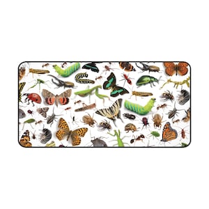 May include: A rectangular desk mat featuring a detailed collage of various insects, including butterflies, moths, beetles, grasshoppers, mantises, and caterpillars in vibrant colors like green, orange, black, and brown against a white background.