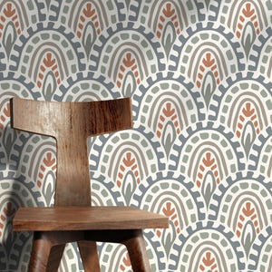 May include: A wooden chair with a curved back and seat stands before wallpaper featuring a repeating pattern of grey, white, and rust-coloured arches. The chair is made of warm-toned wood.