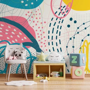 May include: A colourful children's room with an abstract patterned wall in pink, teal, and yellow. A cat-shaped chair holds panda and star pillows. A wooden bench holds cloud and star pillows, and toy blocks.