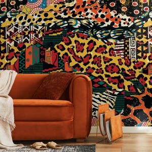 May include: An orange velvet sofa with a matching cushion and throw. The background features a colourful patchwork wallpaper with abstract patterns and animal prints. A gold magazine rack and sandals are in the foreground.