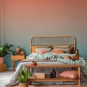 May include: A bedroom scene with a rattan headboard, wooden nightstand, and a wooden bench at the foot of the bed. The bed is made with various pillows and a light green blanket. The wall has a gradient of colors from orange to teal.