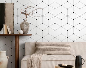 May include: A modern living room with a white geometric patterned wall. A wooden console table holds books, a vase with branches, and a decorative sphere. A beige sofa with a striped pillow and a wooden coffee table complete the scene.