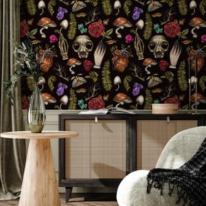 May include: Black and white wallpaper with a repeating pattern of skulls, hearts, mushrooms, flowers, and crystals. The wallpaper is in a room with a wooden cabinet and a side table.