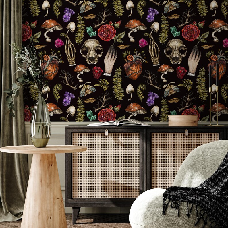 May include: Black and white wallpaper with a repeating pattern of skulls, hearts, mushrooms, flowers, and crystals. The wallpaper is in a room with a wooden cabinet and a side table.