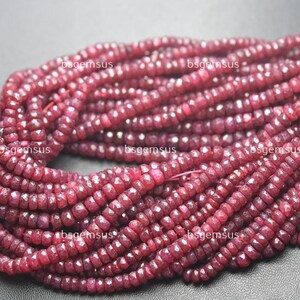 May include: Strands of faceted, deep red ruby beads. The beads are small, uniform in size, and strung together, creating a textured, layered effect. The color is a rich, saturated red, with hints of darker tones. Ideal for jewelry making.