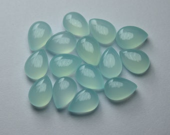 May include: A collection of 16 teardrop-shaped, light blue gemstones. The stones are smooth and polished, with a translucent appearance.