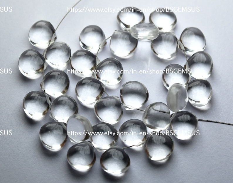 May include: A strand of clear, faceted, round glass beads. The beads are strung on a thin wire and are approximately 10mm in diameter.