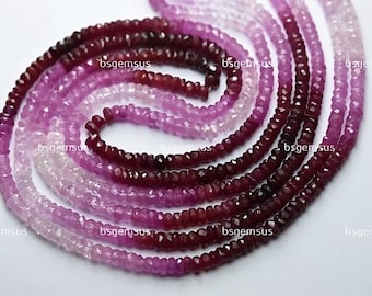 May include: A strand of faceted pink and red gemstone beads. The beads are graduated in size, with the larger beads at the bottom of the strand. The beads are all faceted, giving them a sparkly appearance.