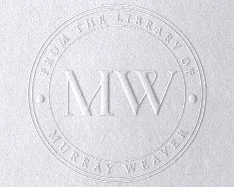 May include: A white circle with the text "From the Library of Murray Weaver" and the initials "MW" in the center.