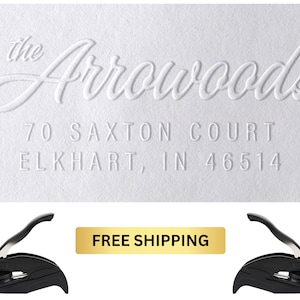 May include: White embossed return address label with the text "the Arrowoods 70 Saxton Court Elkhart, IN 46514". The label is next to two black self-inking stamps.