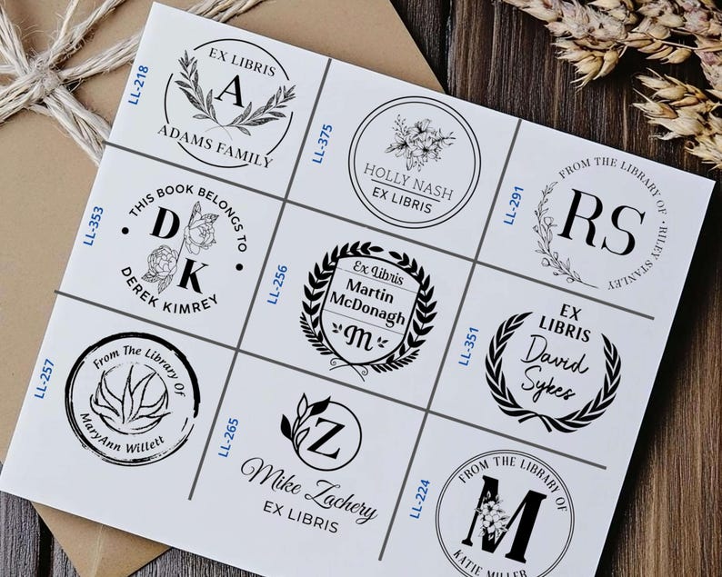 May include: A white sheet of paper with nine different black and white bookplate designs. Each design features a different initial, name, and text. The text includes "Ex Libris", "From the Library of", and "This Book Belongs To".