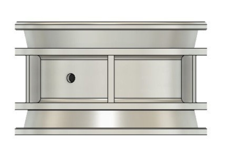 May include: A silver metal ring with two compartments, each with a small hole in the center. The ring is designed to hold small items, such as keys or jewelry.