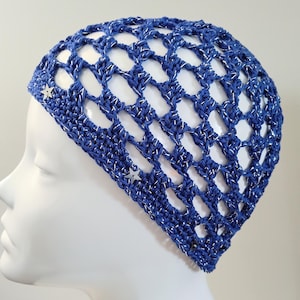 May include: A blue crochet hat with a silver sparkle thread and silver star embellishments.