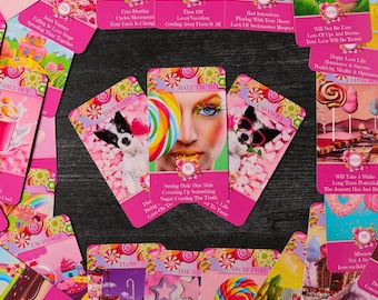 May include: A set of pink and white oracle cards with colorful candy and sweet treats on the front of each card. The cards feature phrases like "Half Truth", "Casanova", "Thoughts", and "Will Take A While".
