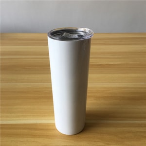 May include: White stainless steel tumbler with a clear lid. The tumbler is tall and slender.