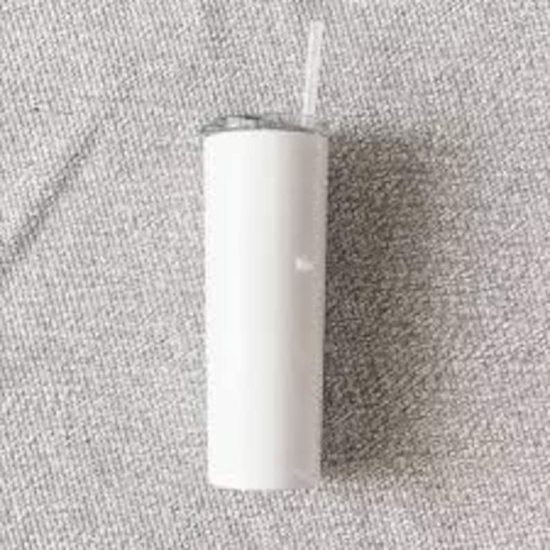 May include: A white, stainless steel tumbler with a lid and a straw. The tumbler is empty and has a smooth, shiny finish.