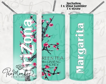 May include: A set of three 20 ounce stainless steel tumblers with different designs. The first tumbler features a pink cherry blossom design with the text "AriZona" in white. The second tumbler features a pink cherry blossom design with the text "Green Tea with Ginseng and Honey" in white. The third tumbler features a pink cherry blossom design with the text "Margarita" in white.