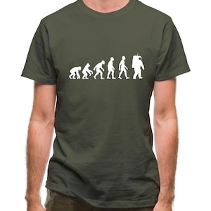 May include: A dark green t-shirt with a white graphic of the evolution of humans ending with an astronaut. The graphic shows a series of stick figures progressing from a monkey to a human to an astronaut.