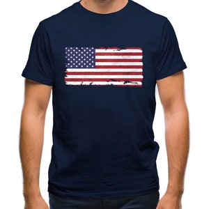 May include: A navy blue t-shirt with a distressed American flag graphic printed on the front.