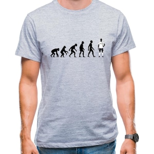 May include: A grey t-shirt featuring a black and white illustration of the evolution of man, culminating in a football player holding a ball.