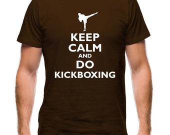 May include: Brown t-shirt featuring a white silhouette of a person performing a kickboxing move. The text "Keep Calm and Do Kickboxing" is printed on the shirt.