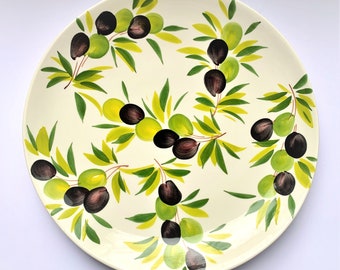 May include: A white ceramic serving platter with a hand-painted design of green olive branches and black olives.