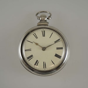 May include: A silver pocket watch with Roman numeral hour markers and a white face.