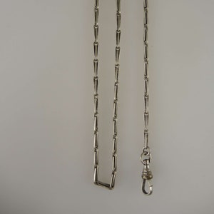 Elegant white metal pocket watch chain c1910