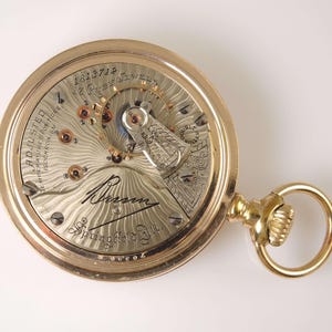 Reloj de bolsillo Illinois Bunn Ruby Jewel, tamaño 18, 17. Damasquinado con efecto rayos de sol, c. 1905.