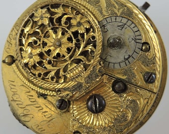 May include: A gold pocket watch with intricate floral engravings and a small dial with Roman numerals. The watch face reads "Mr. Hodgson, Watchmaker, London".