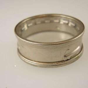 Puede incluir: Un anillo de plata con un dise&ntilde;o decorativo alrededor de la banda.