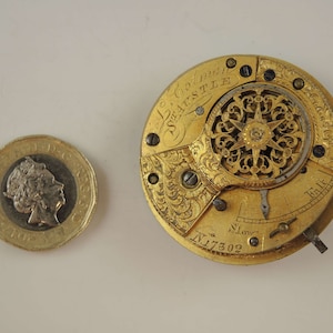 May include: Gold pocket watch with intricate engravings and a detailed clock face. The watch face has the inscription "Le Coultre" and "Seastle" and the number "N.17302".